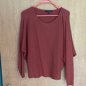 Orange/red sweater. Good condition. Size medium